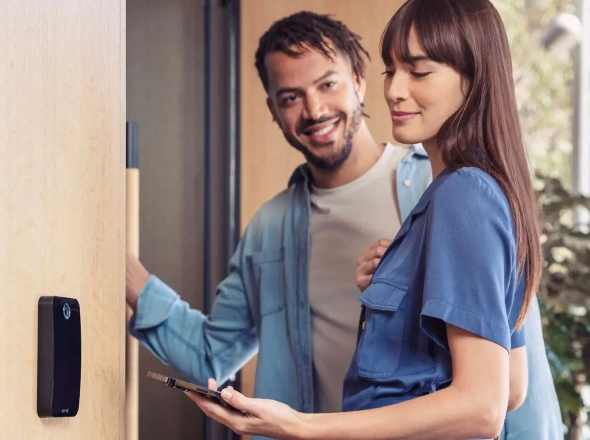 Couple unlocking a door with a phone credential