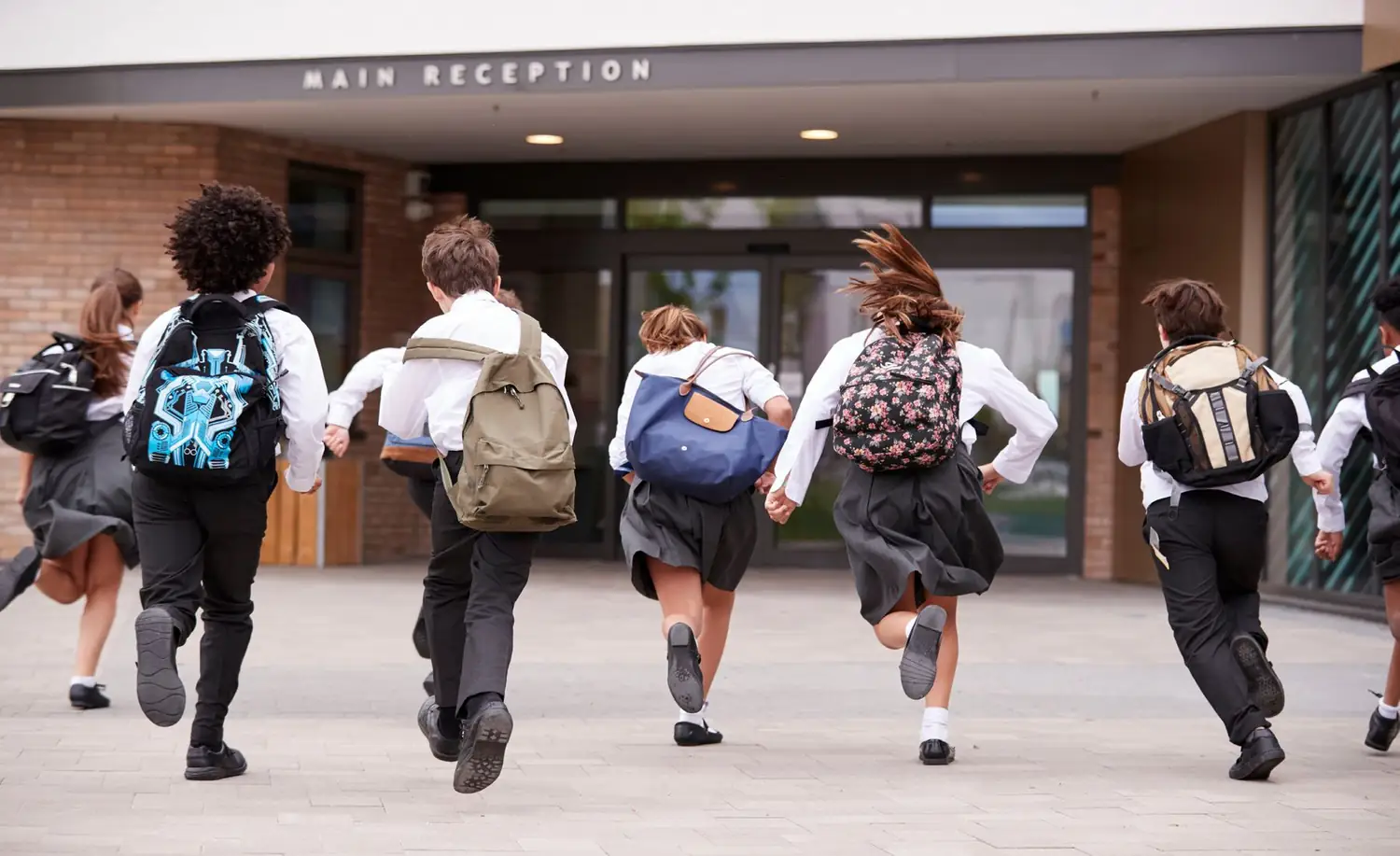 Students walking into a school's main reception